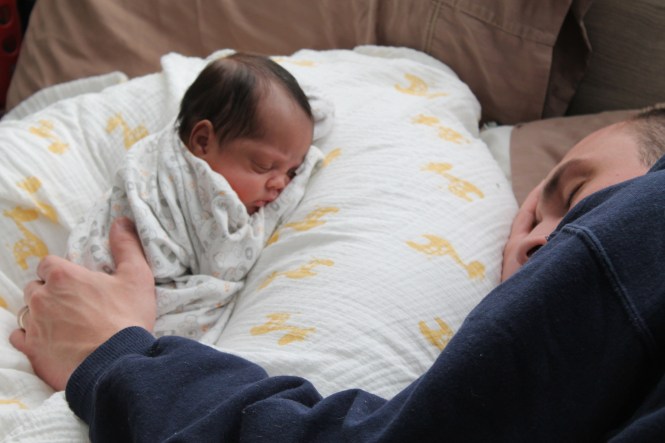 Taking advantage of an opportunity to nap! Michael's sleeping with Michaela on the couch shortly after she came home.